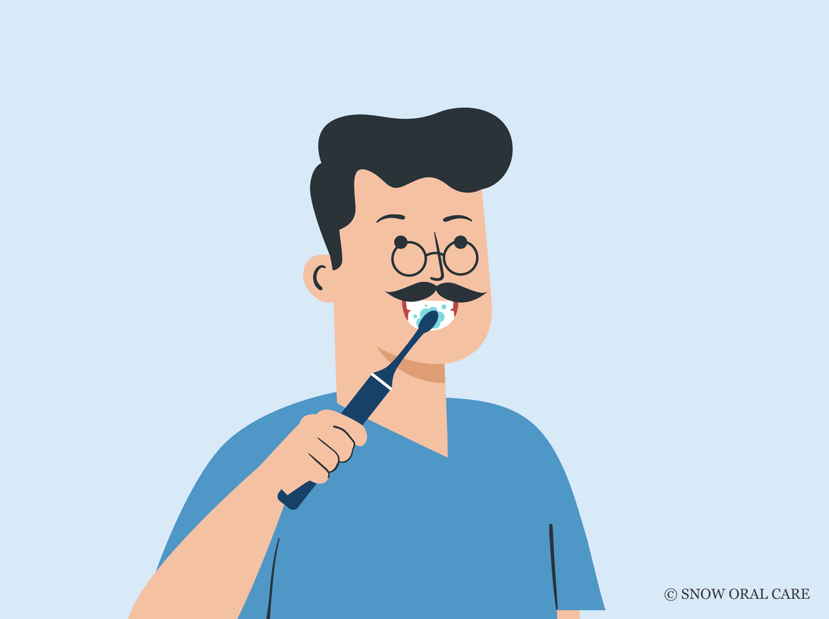 how should you hold the toothbrush during brushing