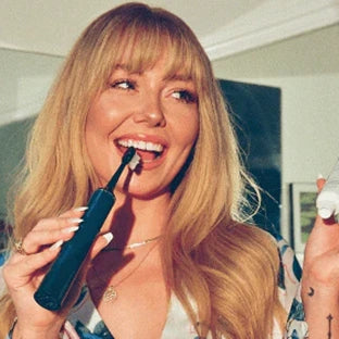 Woman using Snow Gold Teeth Whitening Pen – at-home solution for a brighter smile