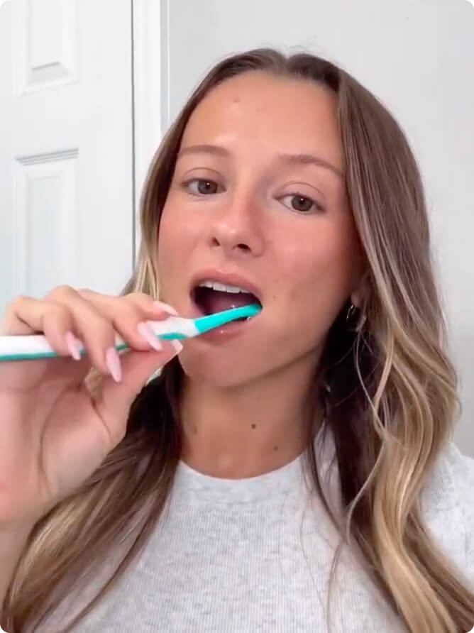 Woman brushing with the purple powder